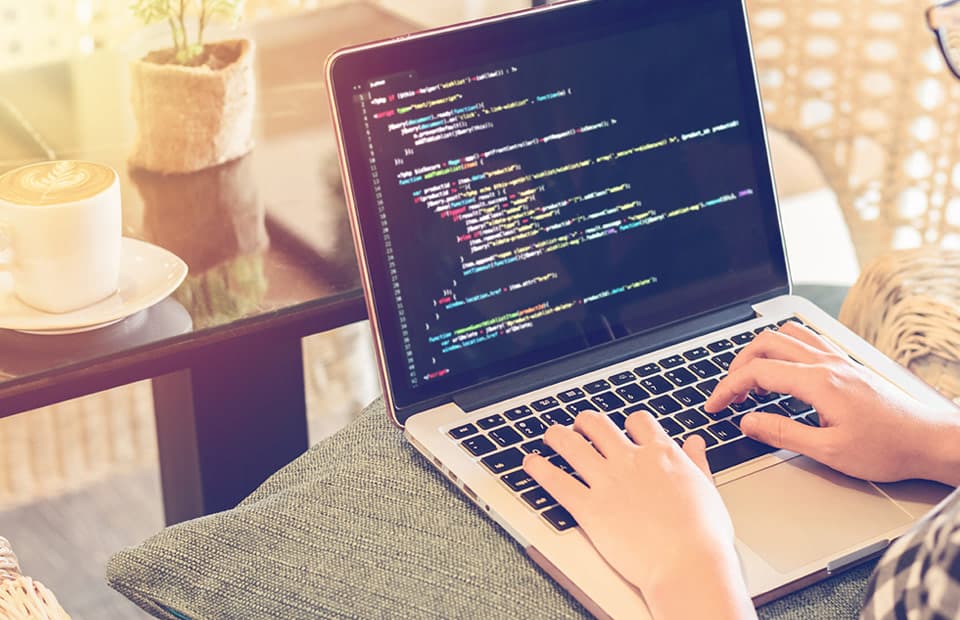 Laptop computer being used to write code